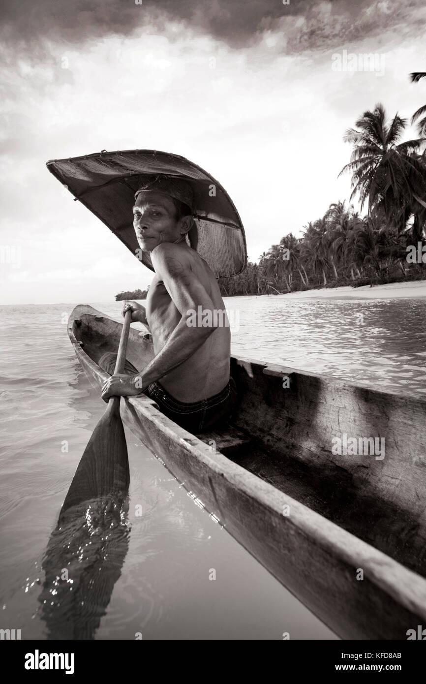 INDONESIA, Mentawai Islands, Kandui Resort, portrait of a Mentawai fisherman, Gesayas Ges, in his dugout canoe (B&W) Stock Photo