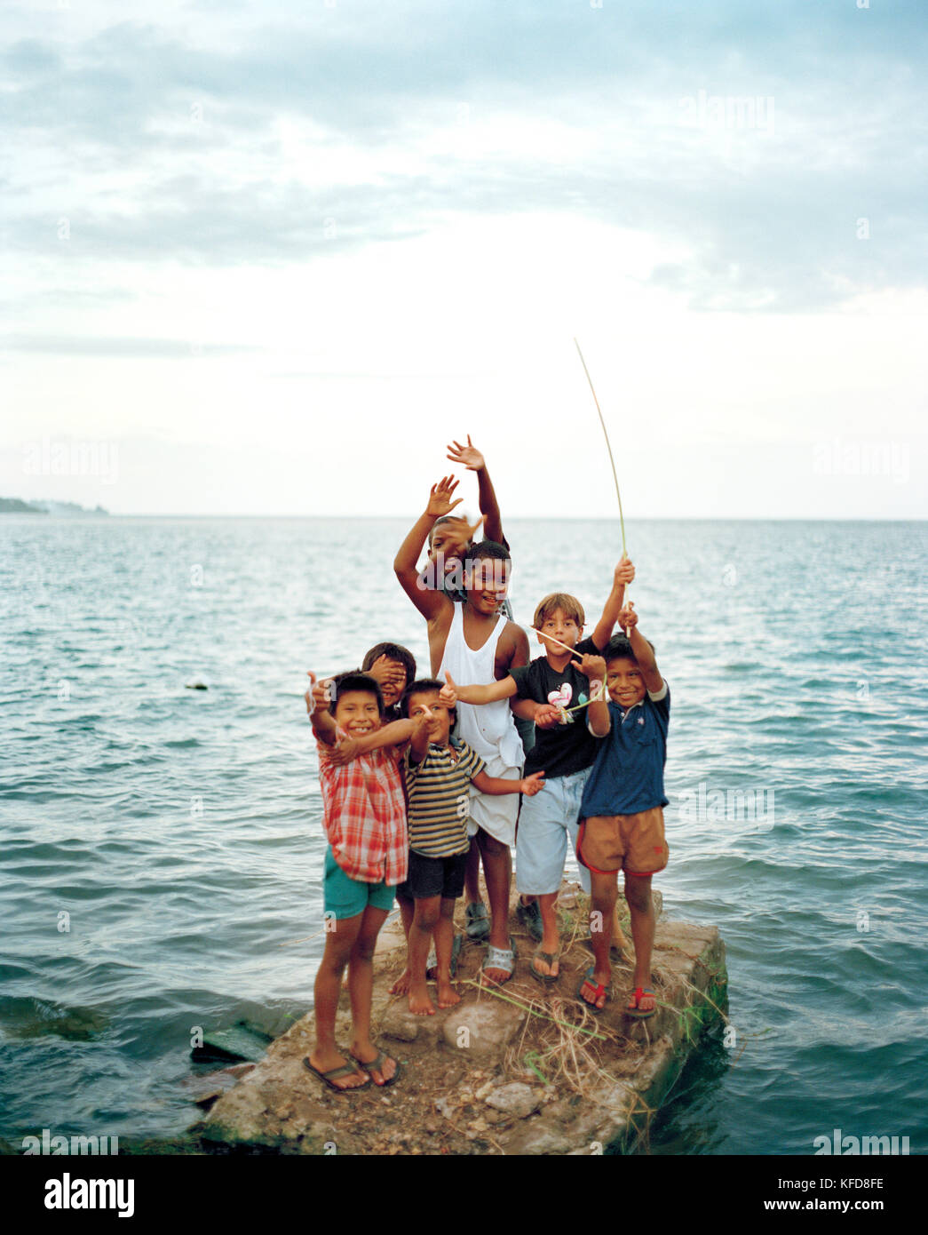 PANAMA, Bocas del Toro, a group of kids playing by the sea Stock Photo