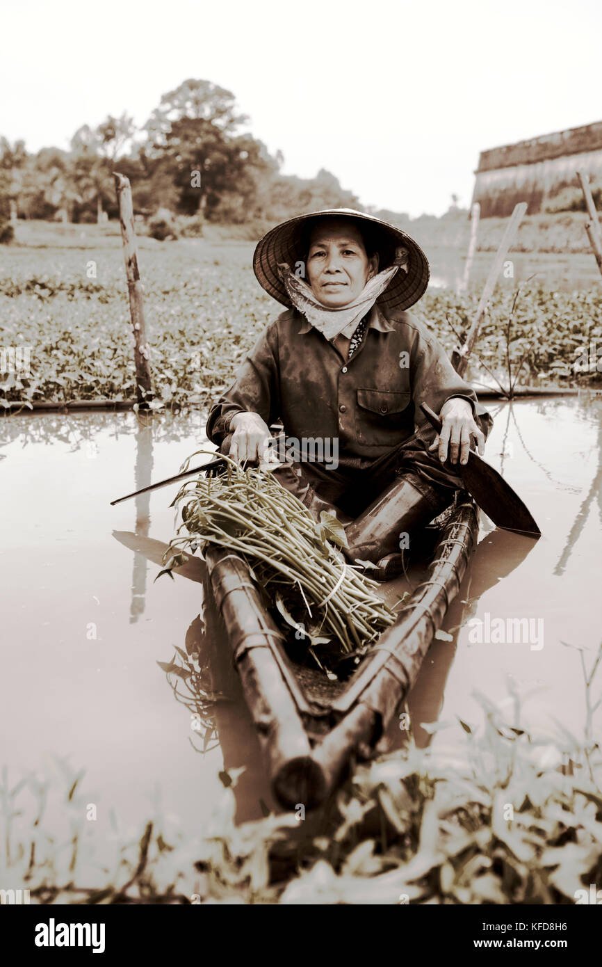 VIETNAM, Hue, portrait of Nguyen Thi Ngan in her small canoe sitting ...