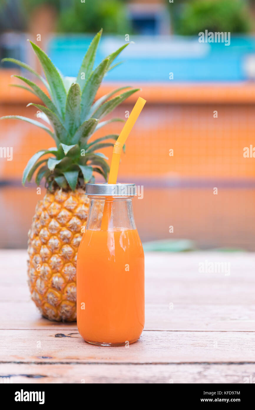 Fresh yellow pineapple tropic fruit summer refreshment smoothie shake drink near pool Stock