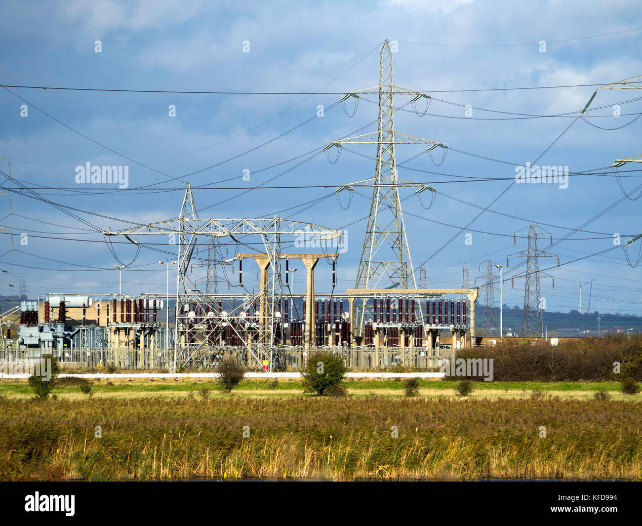 A National Grid  electrical switching sub-station on the 400kV overhead power transmission system with pylons for lines in several directions Stock Photo