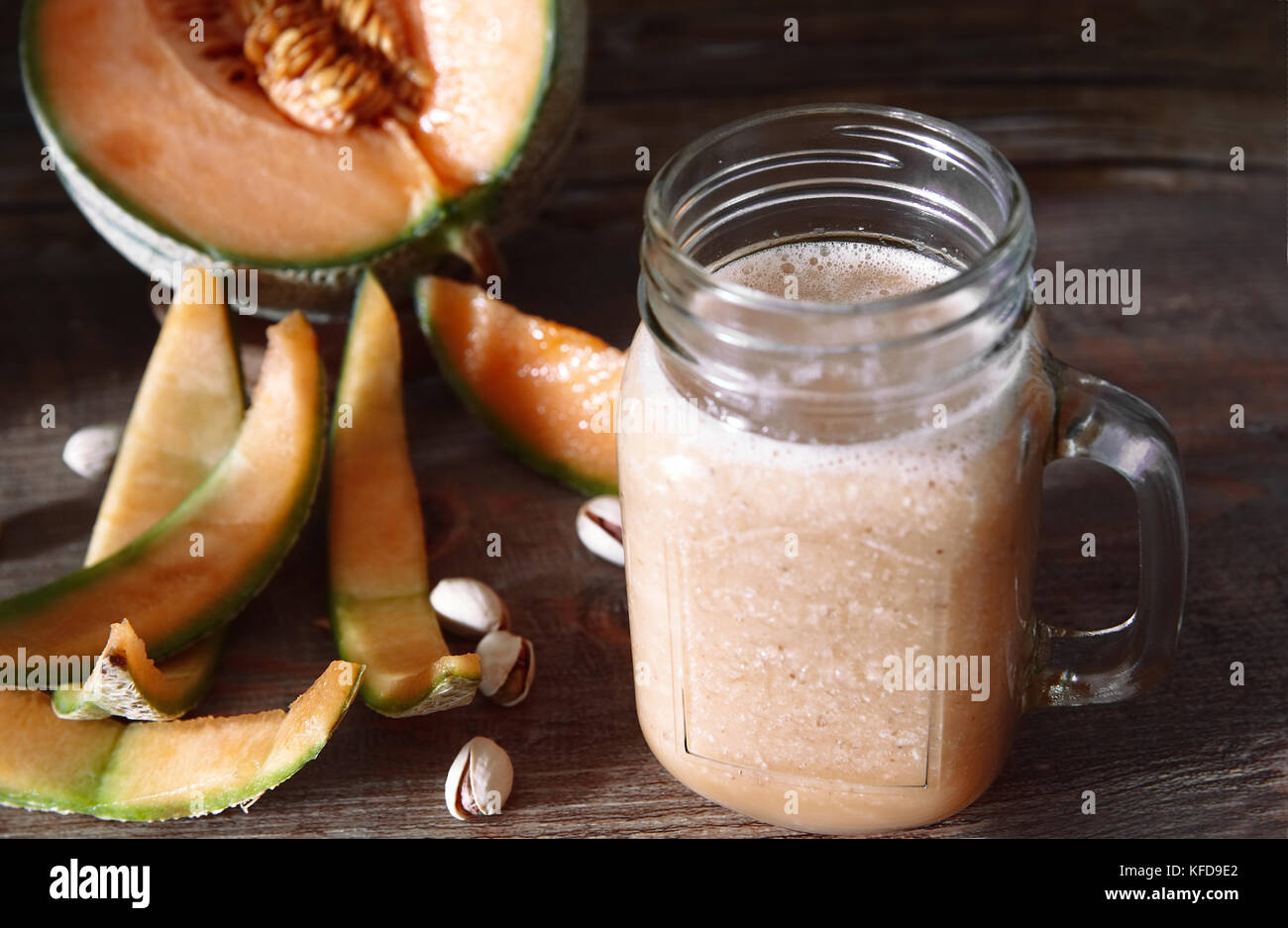 Tasty Smoothies of cantaloupemelon in a glass jar, Whole and sliced