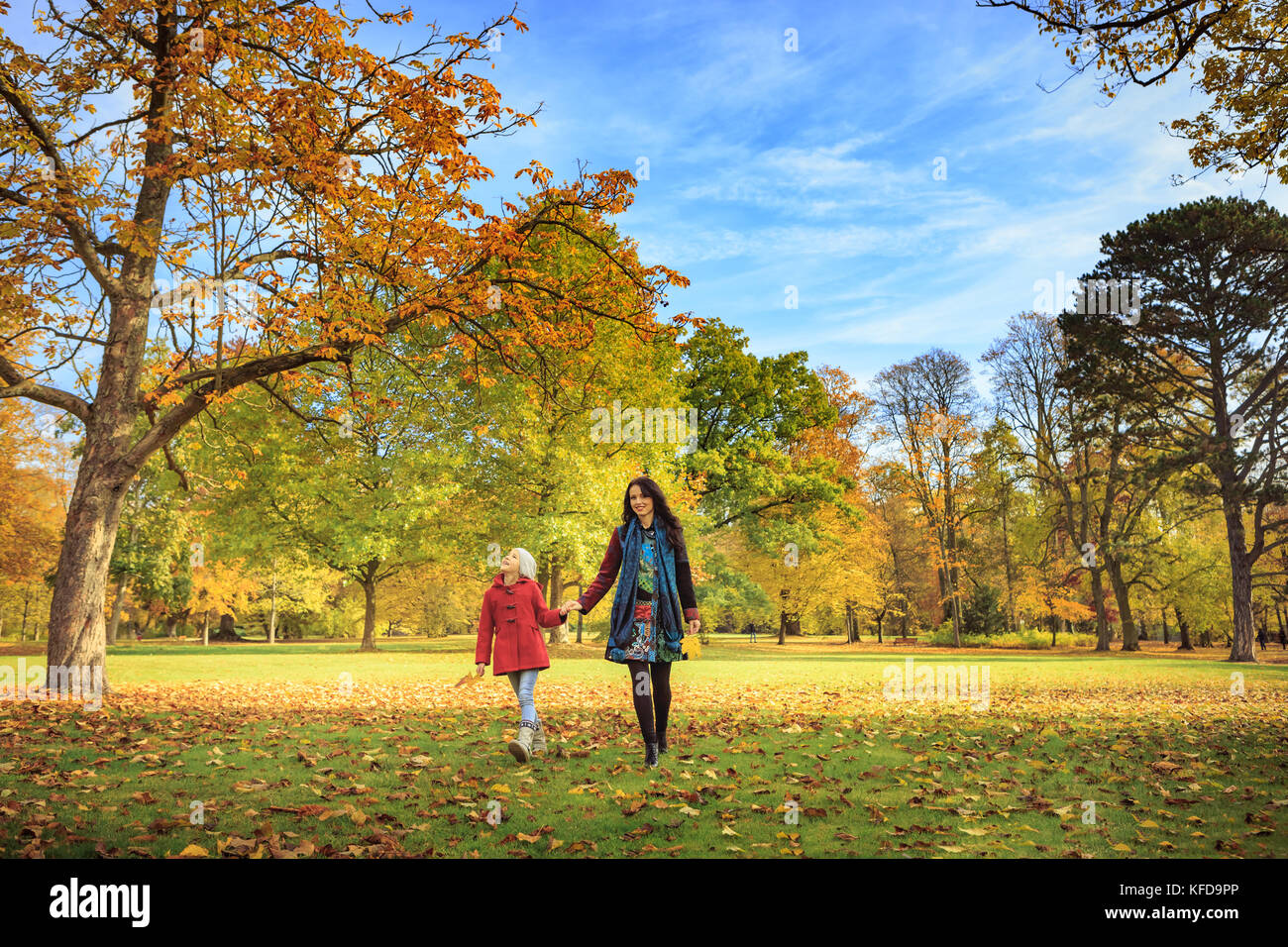 little girl walking with mother in the park Stock Photo - Alamy