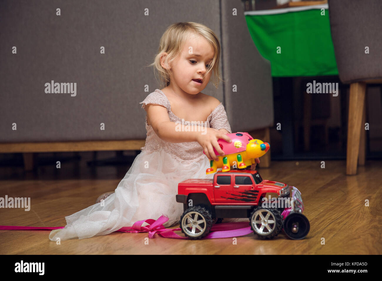 baby girl playing with a toy car Stock Photo Alamy