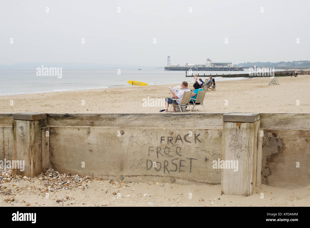 People in deck chairs on the beach at Bournemouth Stock Photo Alamy