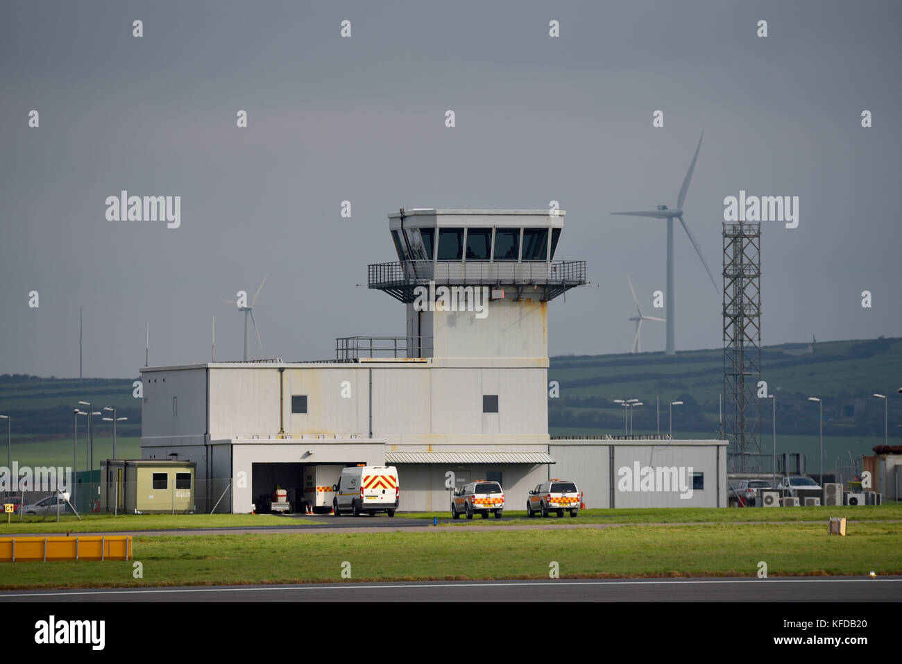 Air traffic control tower at Cornwall Airport Newquay. Wind farm beyond Stock Photo