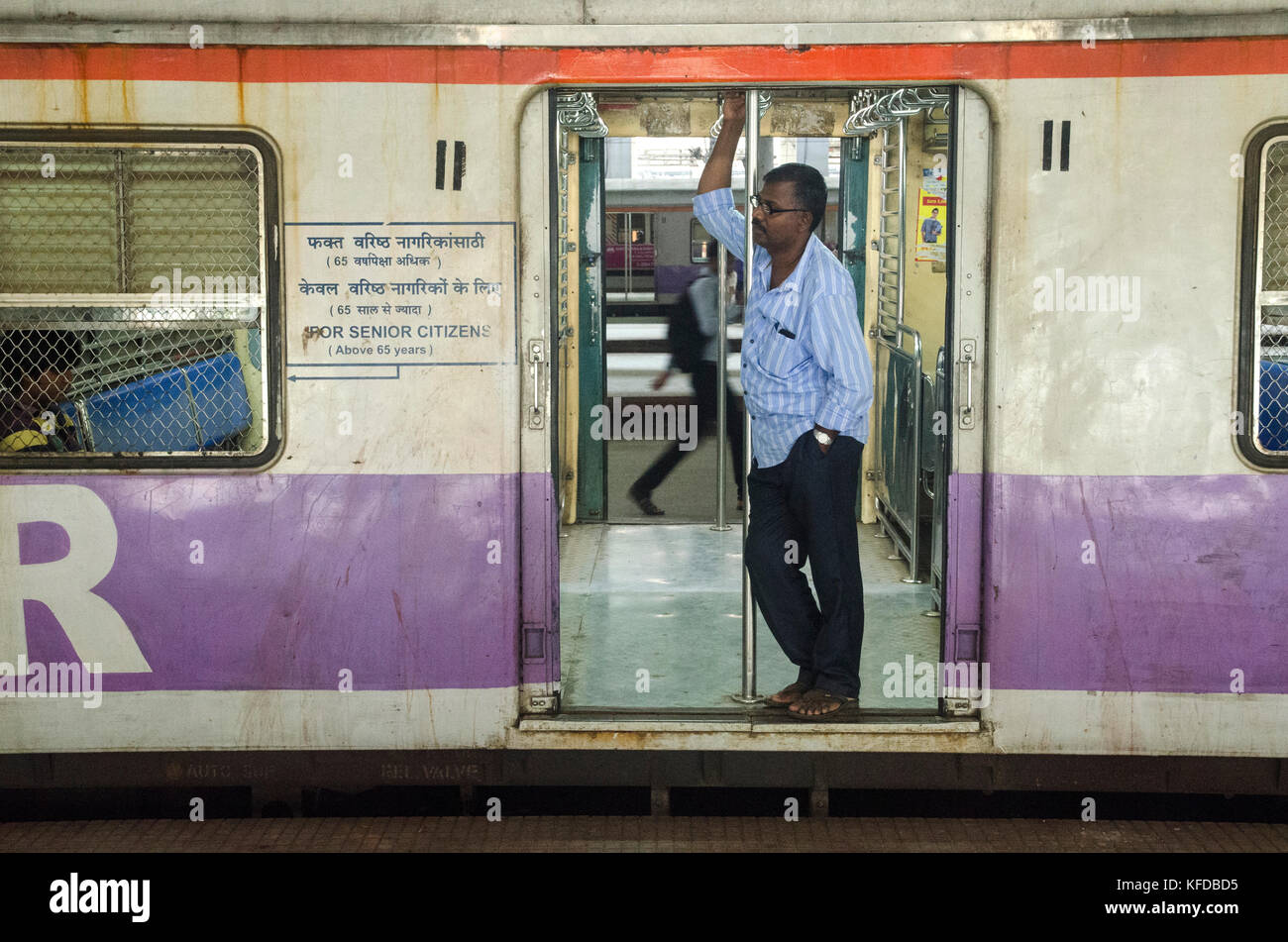 A commuter on a train in Mumbai, India Stock Photo