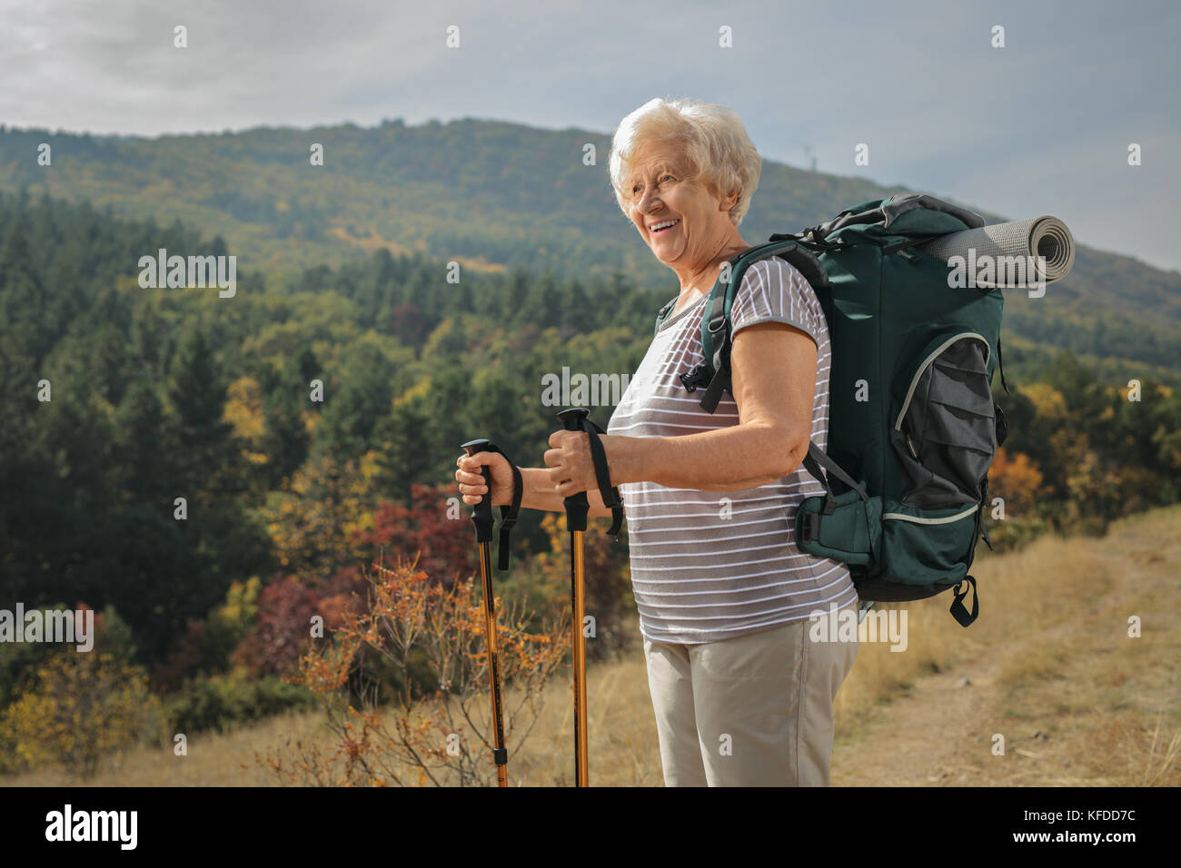 Elderly female hiker looking away outdoors Stock Photo