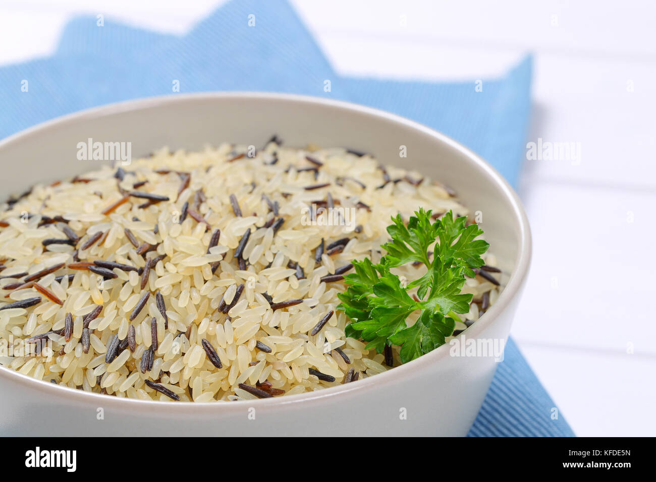 bowl of wild rice on blue place mat close up Stock Photo Alamy