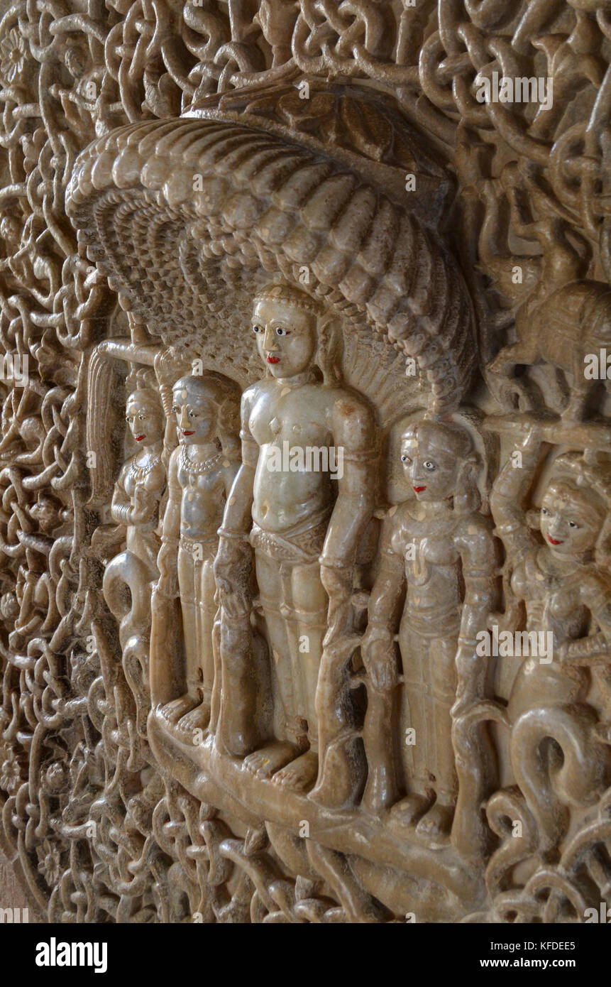 Close up of marble carving of deity of Shri Parshwanathjee surrounded by heads and tails of snakes, Ranakpur Jain Temple, Ranakpur Stock Photo