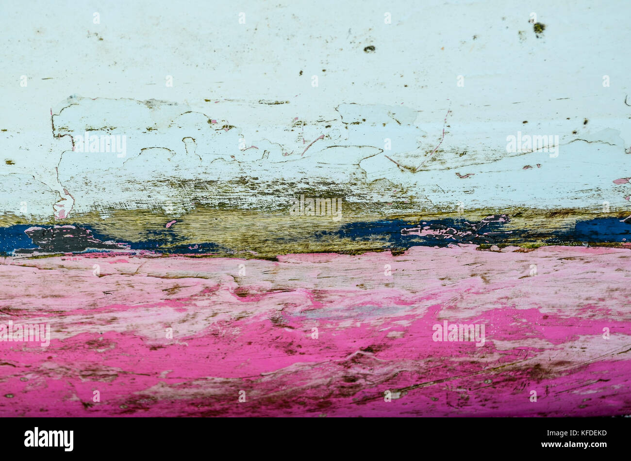 Close up of  pink and white paint on fishing boat hull, with scratches and scuffs. Stock Photo