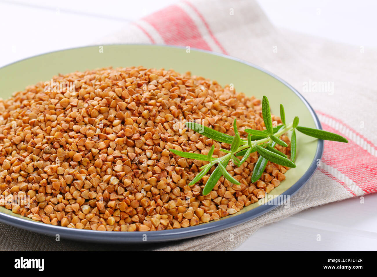 plate of raw buckwheat on place mat - close up Stock Photo