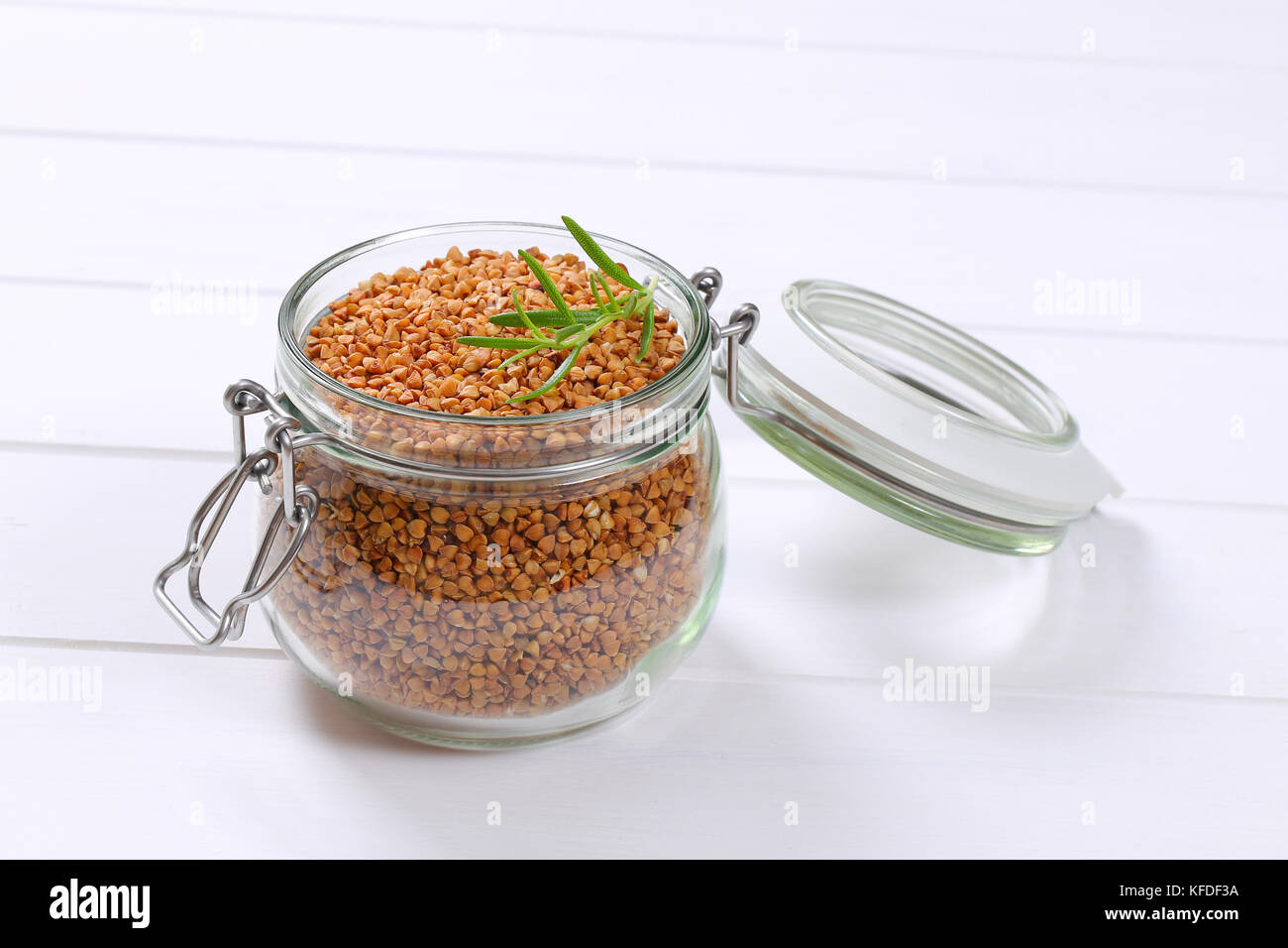 jar of raw buckwheat on white wooden background Stock Photo Alamy