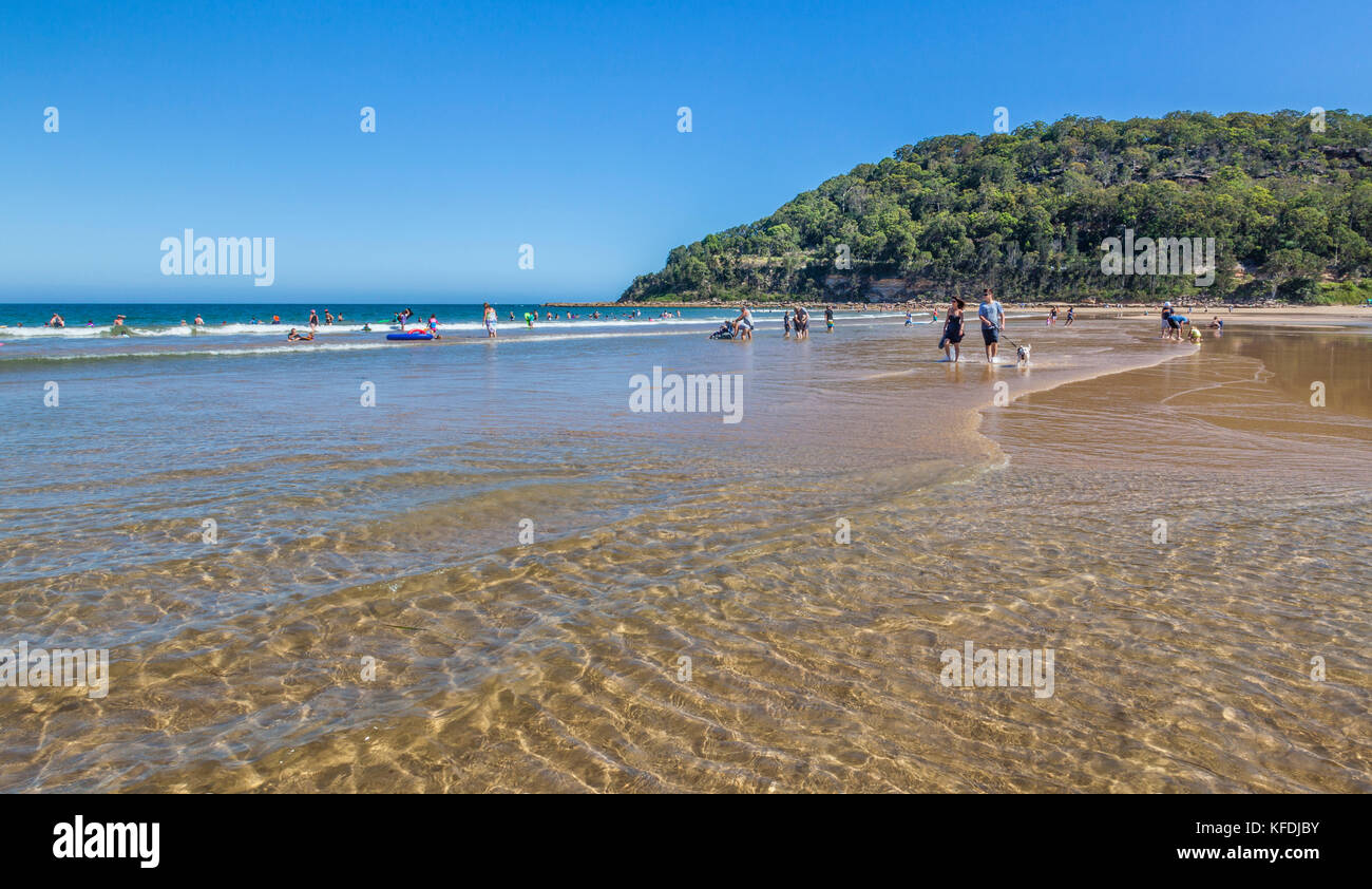 Australia, New South Wales, Central Coast, Umina Beach and Mount Ettalong promontory, beachgoers enjoying the surf Stock Photo