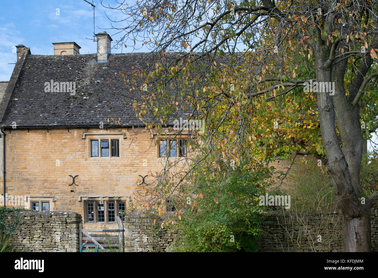 Bourton house exterior and autumn trees in Bourton on the hill. Cotswolds, Gloucestershire, England Stock Photo
