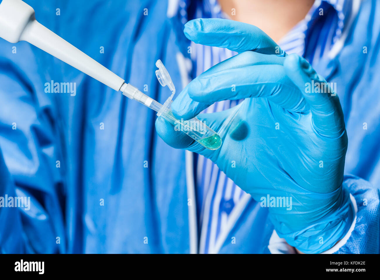 Scientist holding an eppendorf tube and pipette Stock Photo
