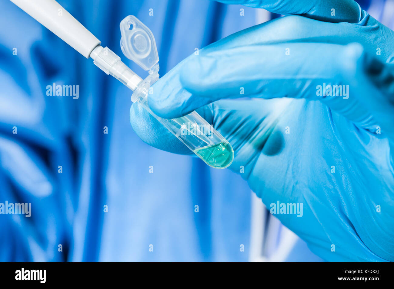 Scientist holding an eppendorf tube and pipette Stock Photo