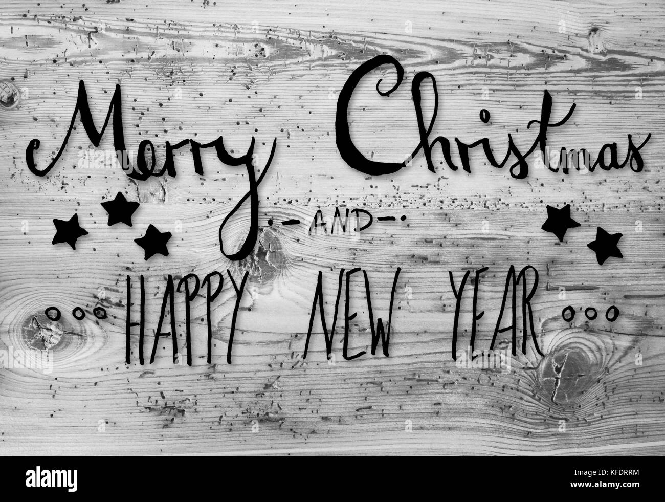 Black English Calligraphy Merry Christmas And Happy New Year. Gray Vintage Wooden Background Stock Photo