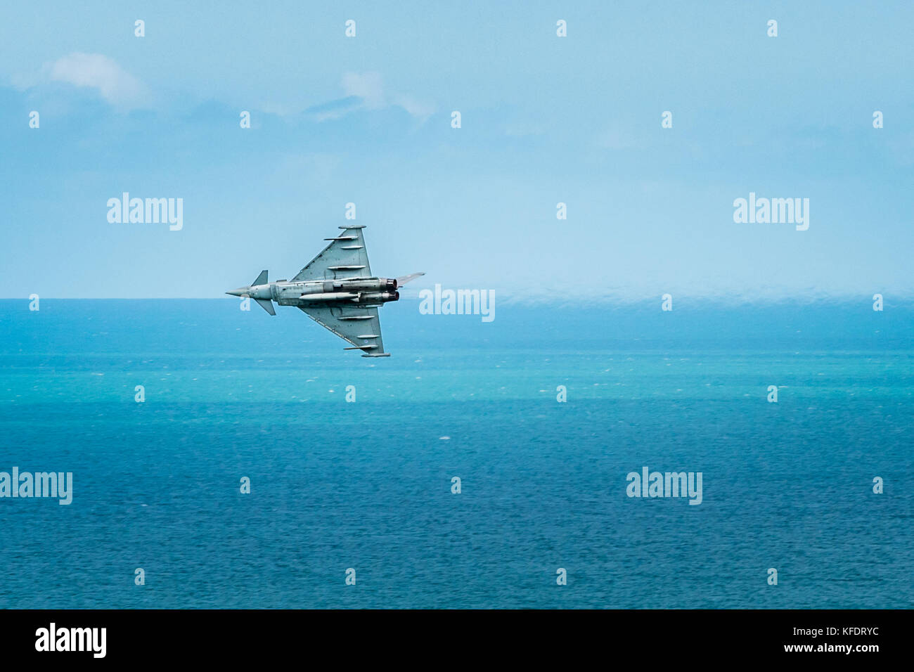 Eurofighter Typhoon Jet flies along horizon above English Channel sea at Eastbourne airshow.display Stock Photo