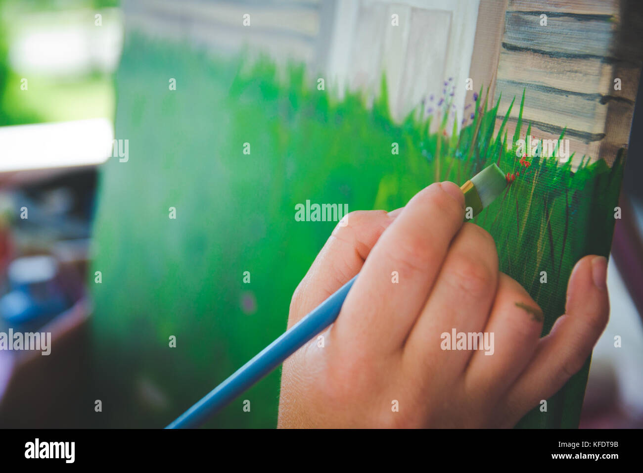 Artist holding paint brush painting canvas Stock Photo Alamy