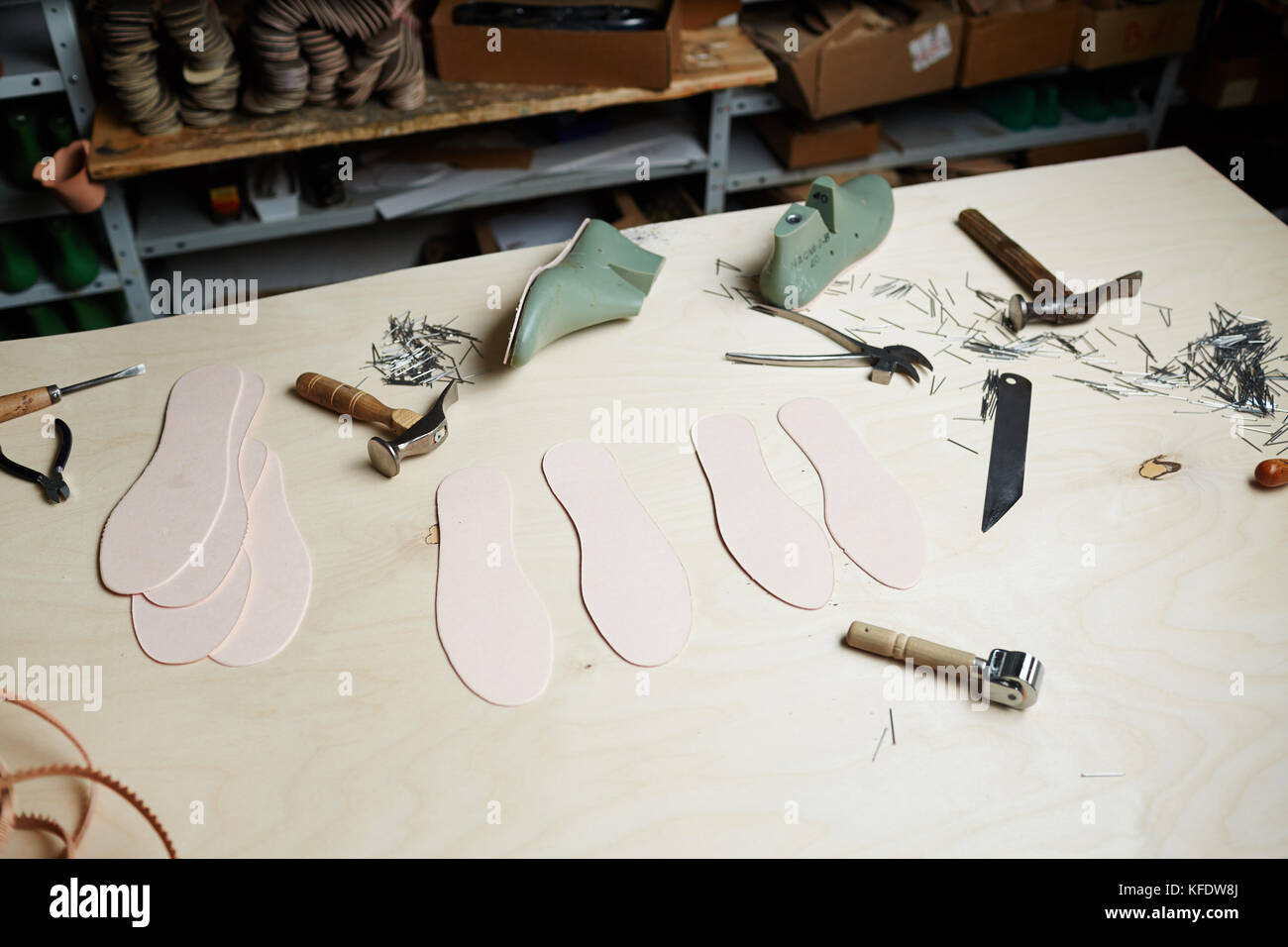 Handtools of shoemaker and workpieces on wooden workplace Stock Photo ...