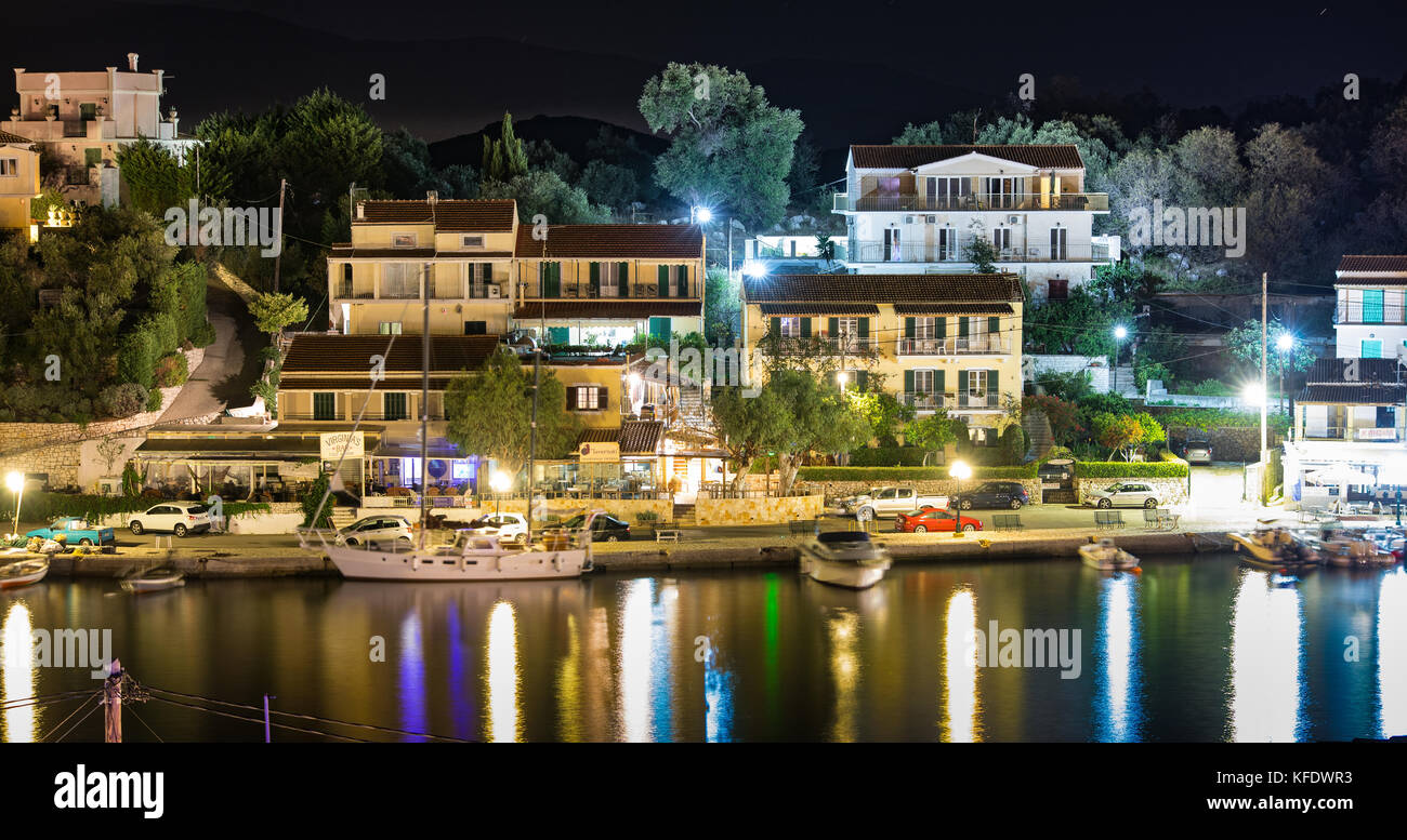 The bay, marina and harbor of Kassiopi as seen from above in the night