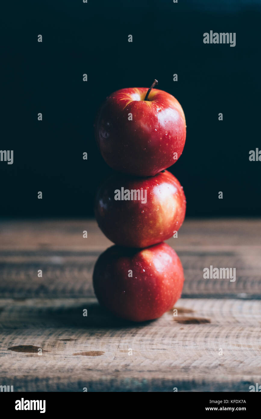 red apple stacked on a wooden table Stock Photo - Alamy