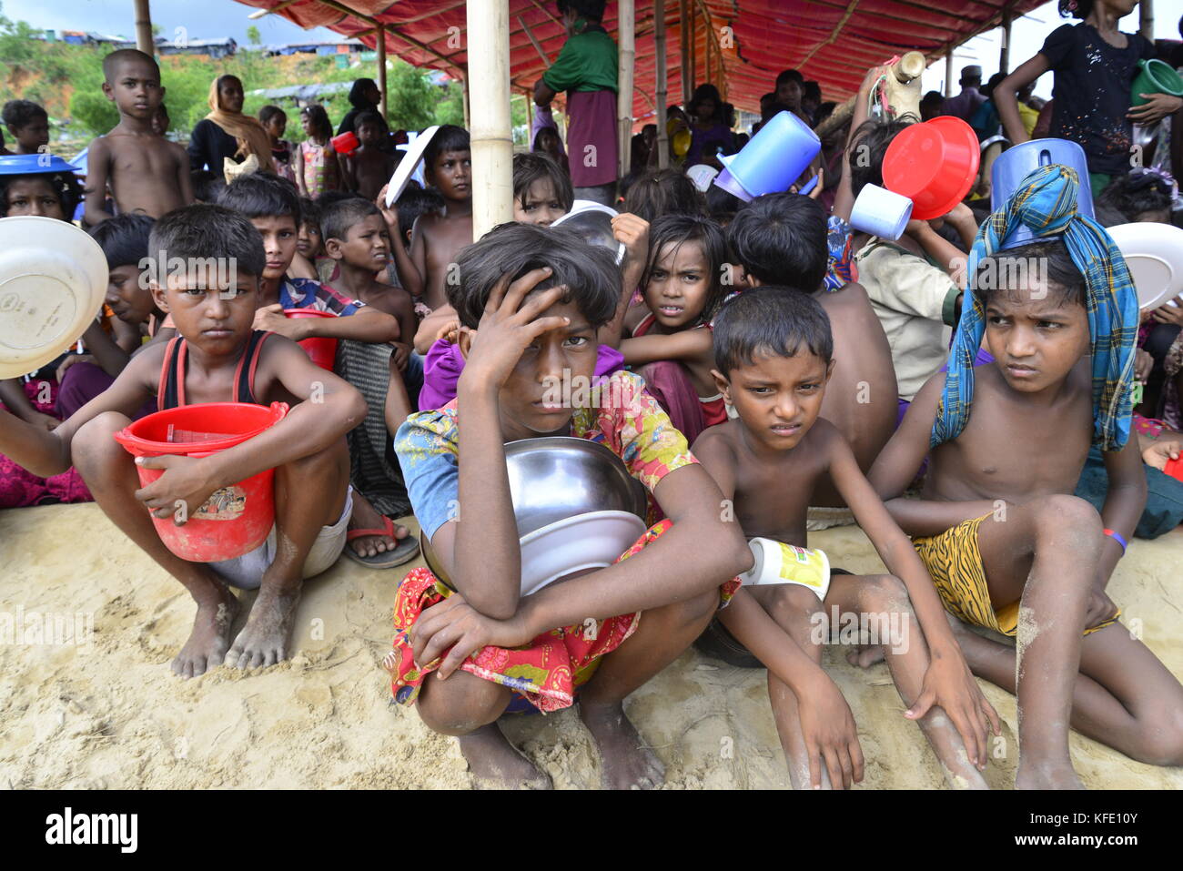 Rohingya refugee children wait to collect food at the palongkhali ...