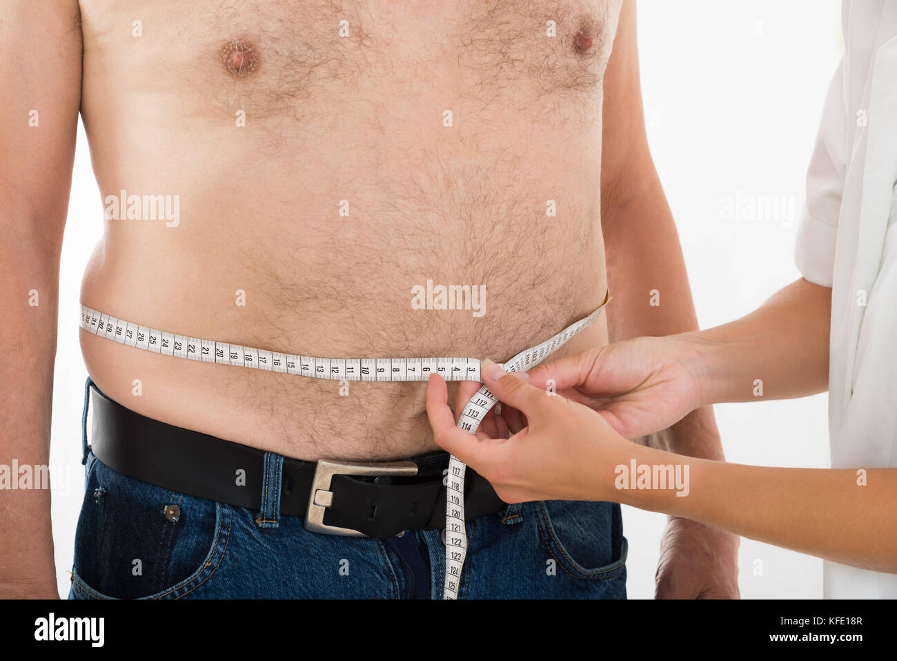 Close-up Of A Doctor Measuring Person's Waist With Measuring Tape Stock Photo