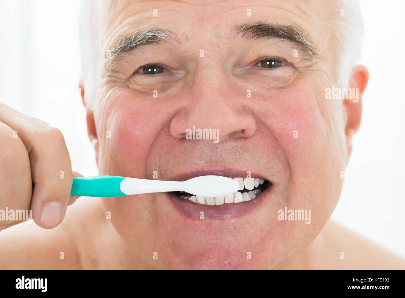 Senior Man Brushing His Teeth With Toothbrush Stock Photo