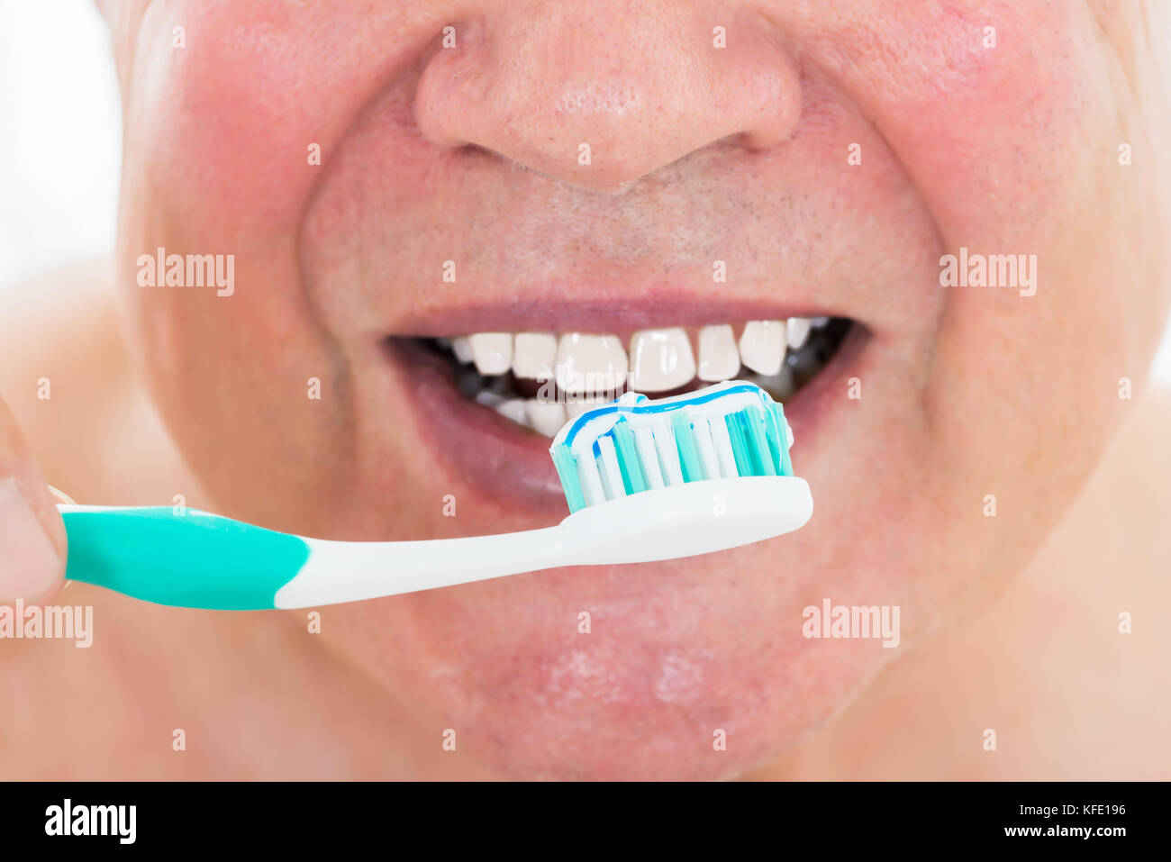 Close-up Of A Man Brushing His Teeth With Toothbrush Stock Photo