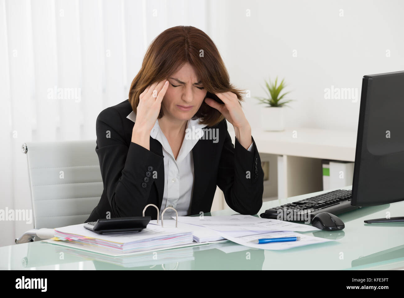 Stressed Businesswoman Sitting In Office With Financial Report Stock ...
