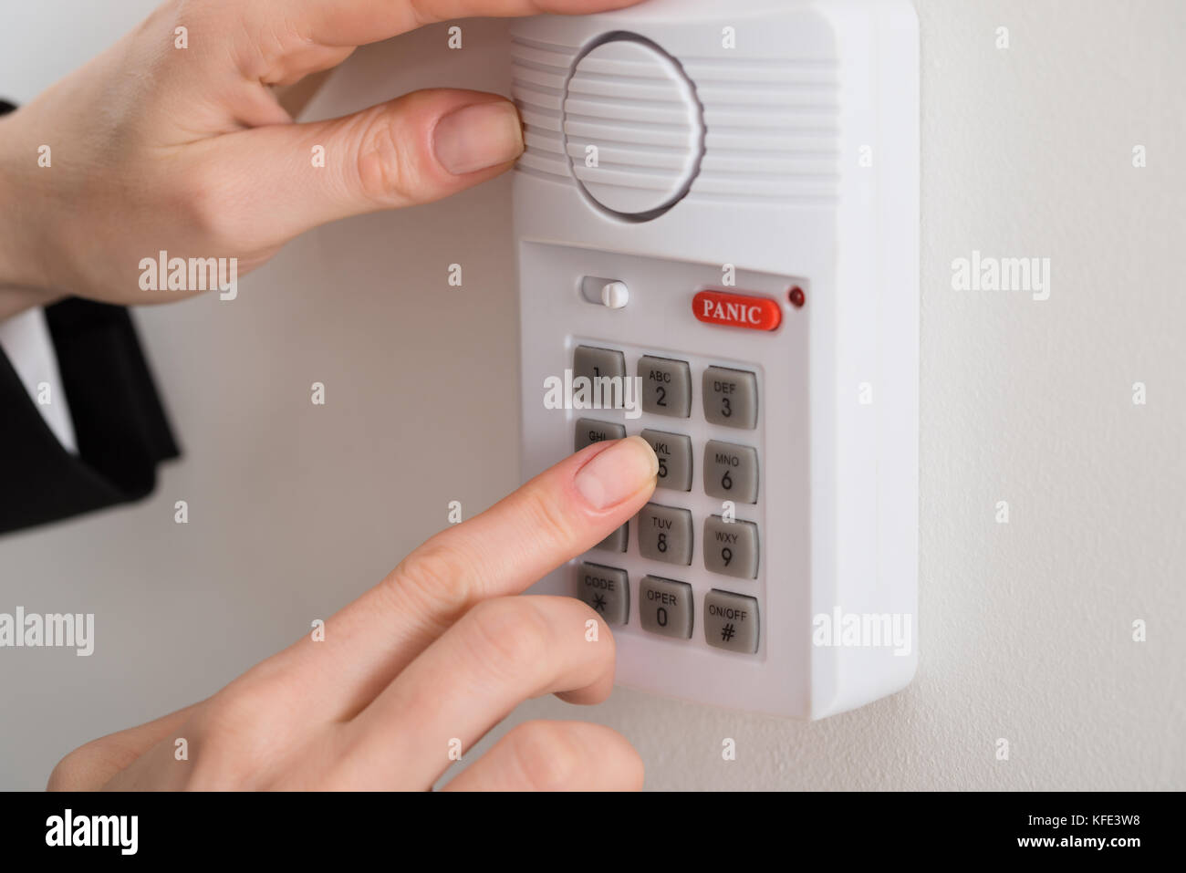 Close-up Of Woman Hand Pressing Button On Security System Stock Photo