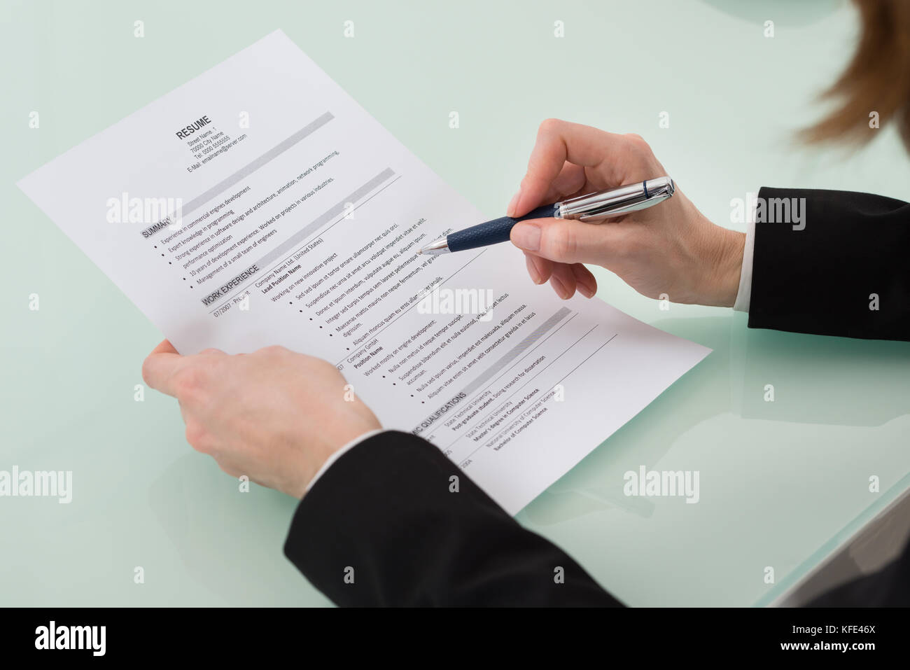 Close-up Photo Of Person Hand Holding Resume Stock Photo