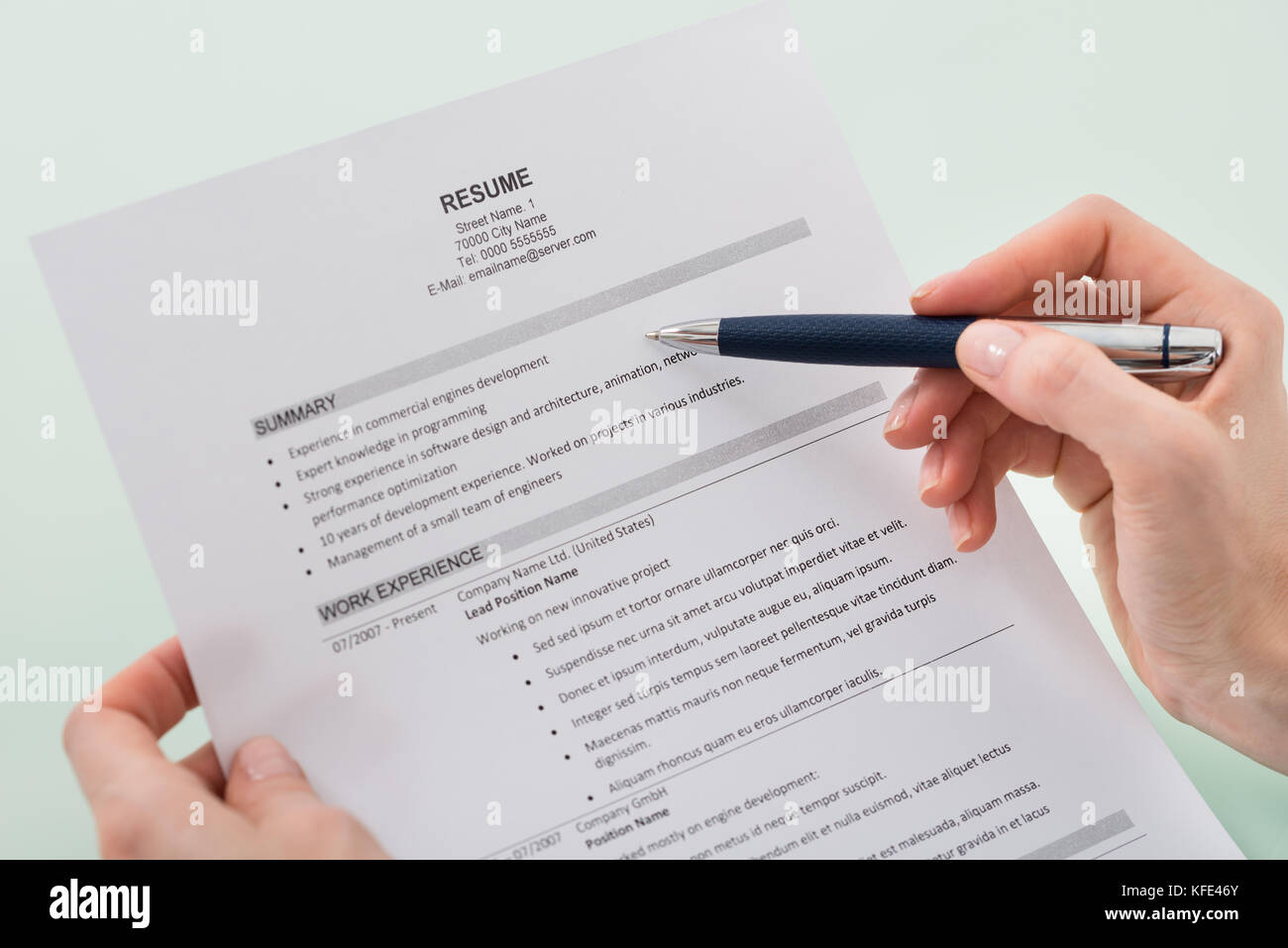 Close-up Photo Of Person Hand Holding Resume Stock Photo