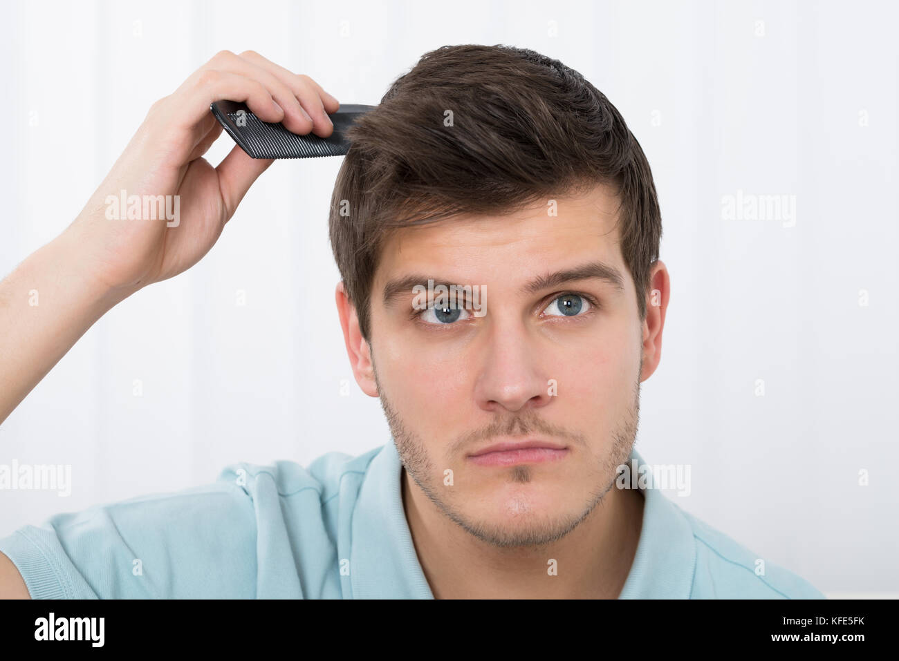 Close-up Of Young Man Combing His Hair With Comb Stock Photo - Alamy