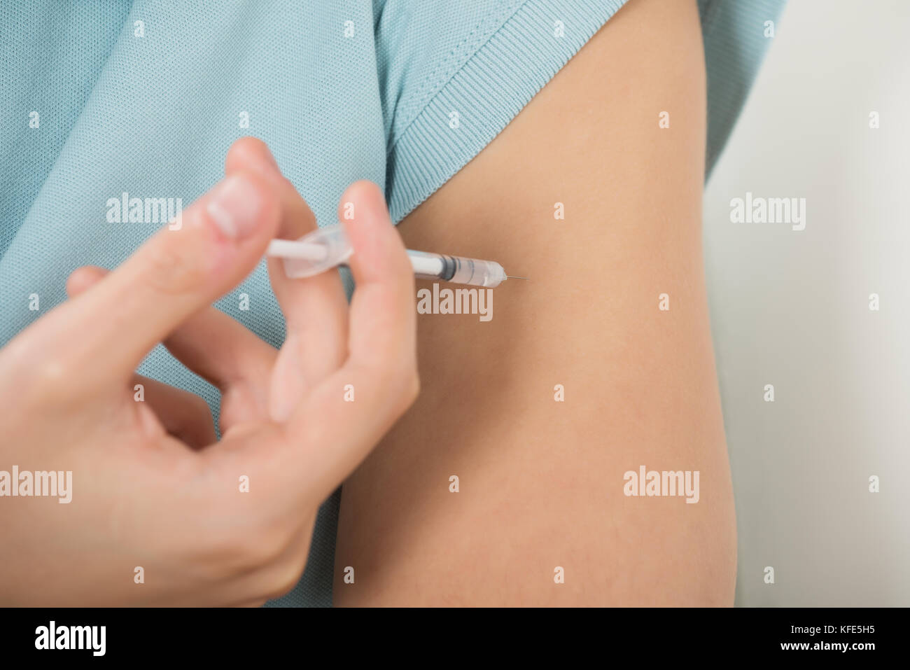 Close-up Of Diabetic Man Injecting Insulin In Arm Stock Photo