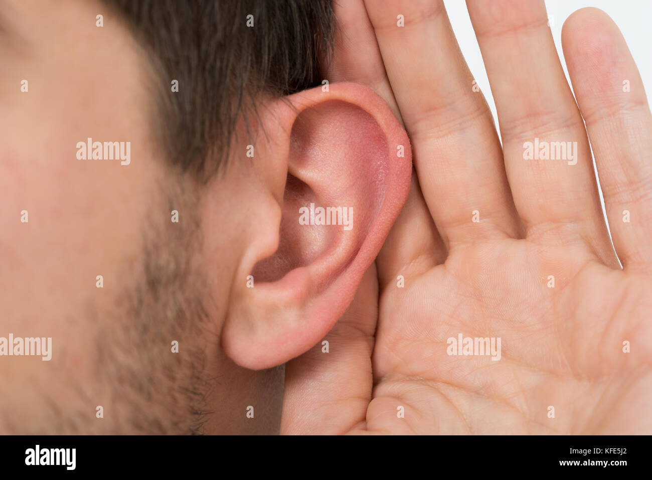 Close-up Of Person Trying To Hear With Hand Over Ear Stock Photo