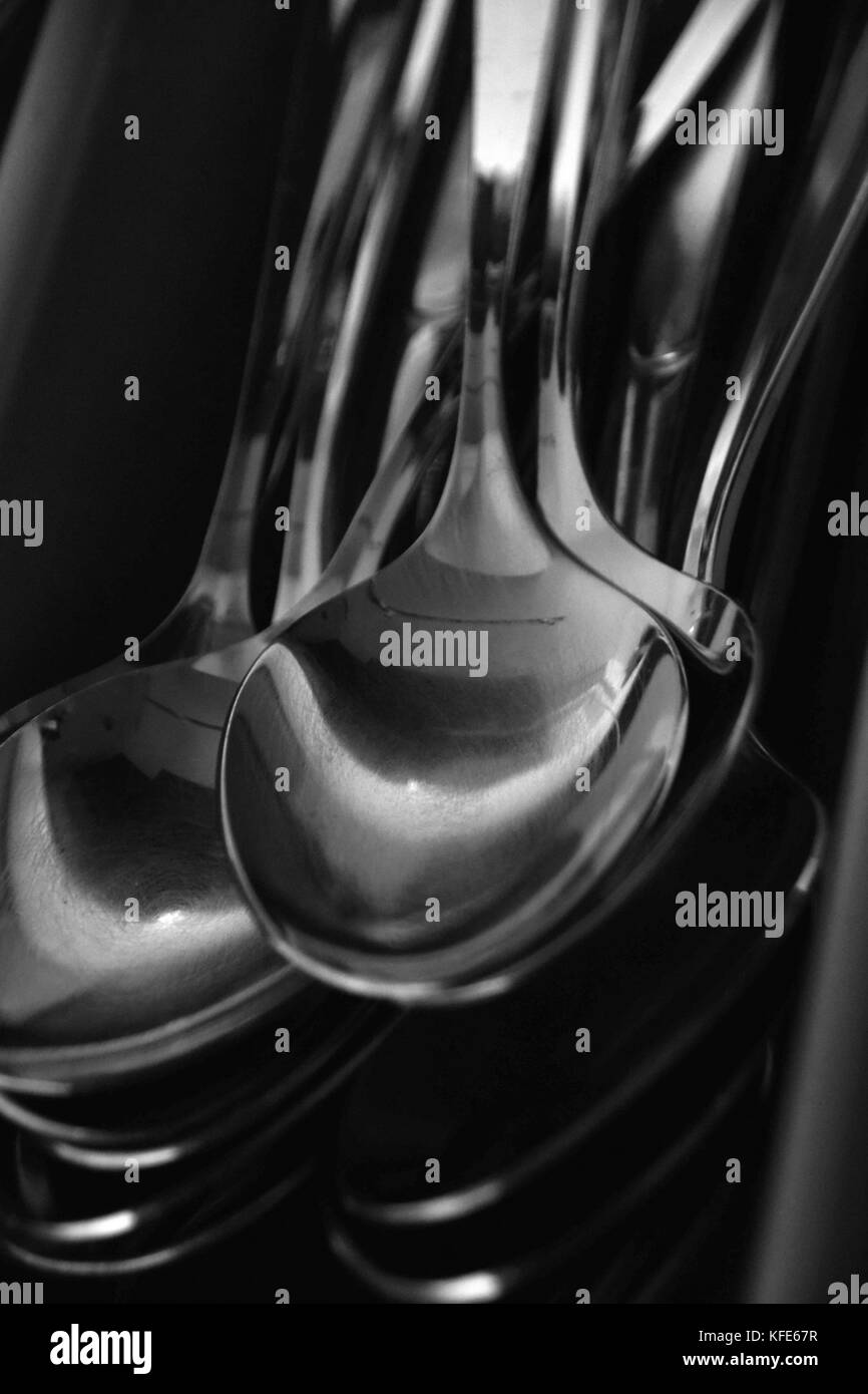 spoons in black and white, abstract stacked spoons in a cutlery rack