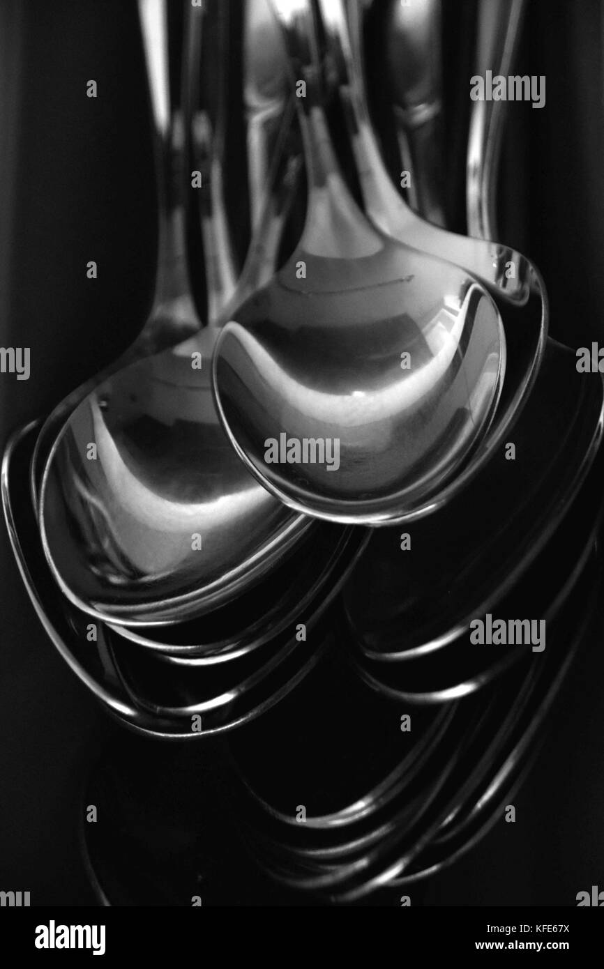 spoons in black and white, abstract stacked spoons in a cutlery rack