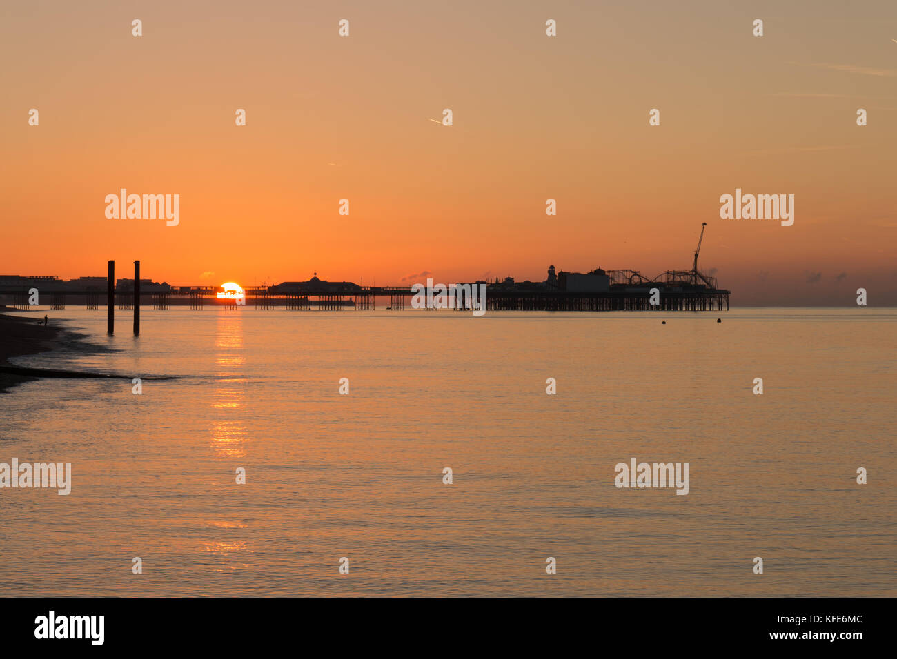 The Sun Rises Behind the Palace Pier, Brighton Stock Photo