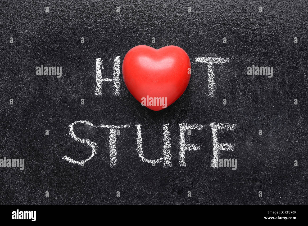 hot stuff phrase handwritten on blackboard with heart symbol instead of O Stock Photo