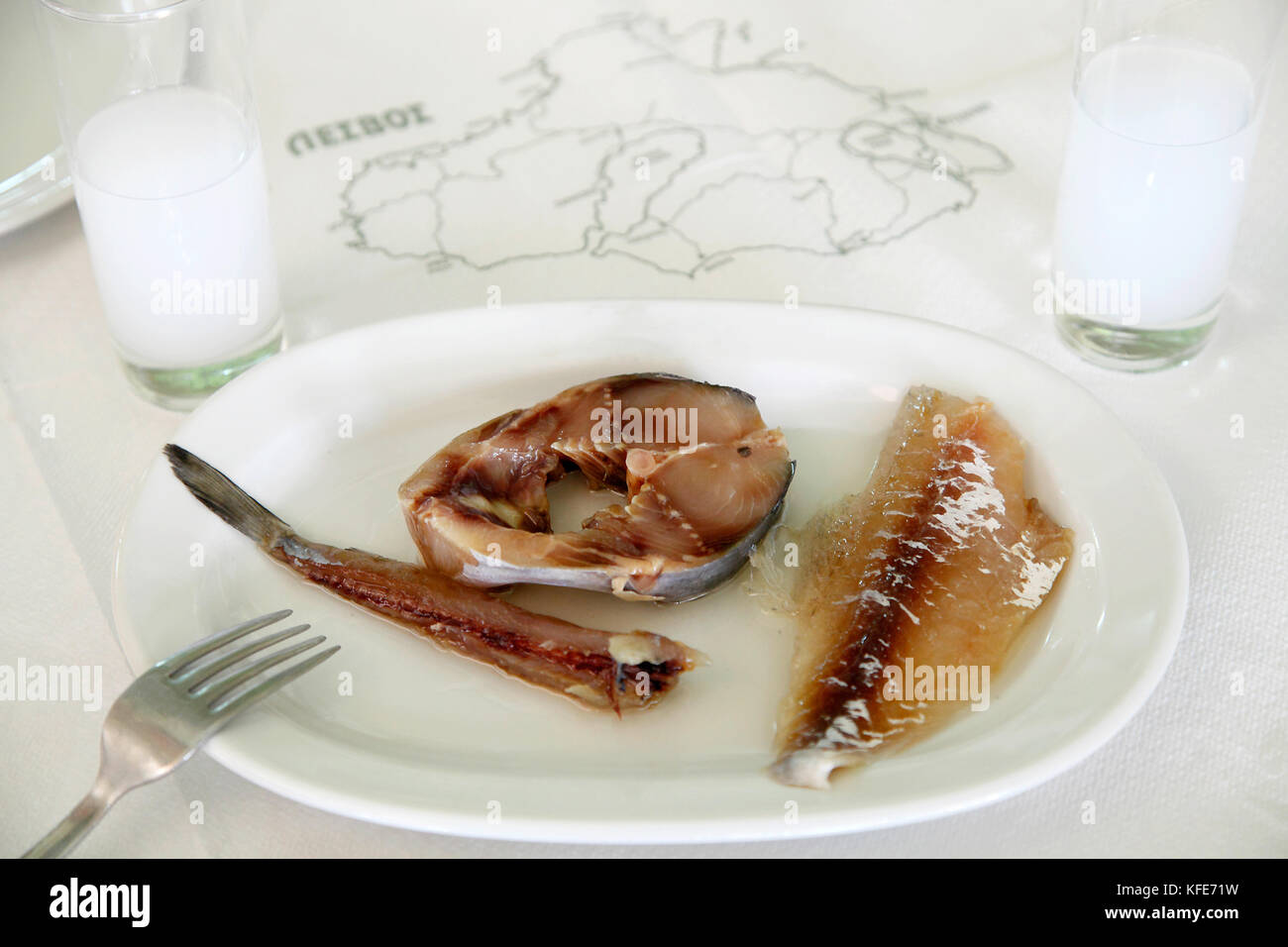 Greek traditional seafood, sardine, potted fish and fish fillet, and ouzo from the island of Lesvos, Greece. Stock Photo