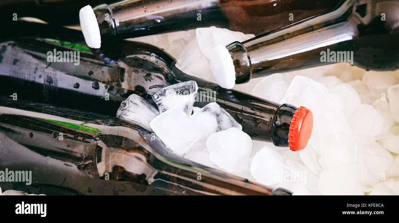 Frozen beer bottles on ice cubes background Stock Photo Alamy