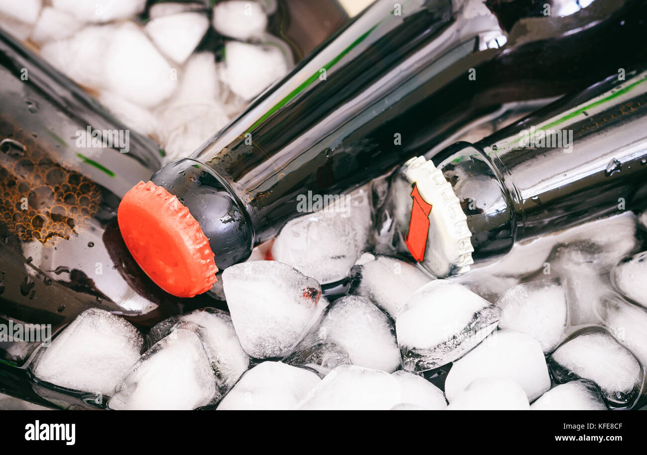 Frozen beer bottles on ice cubes background Stock Photo Alamy