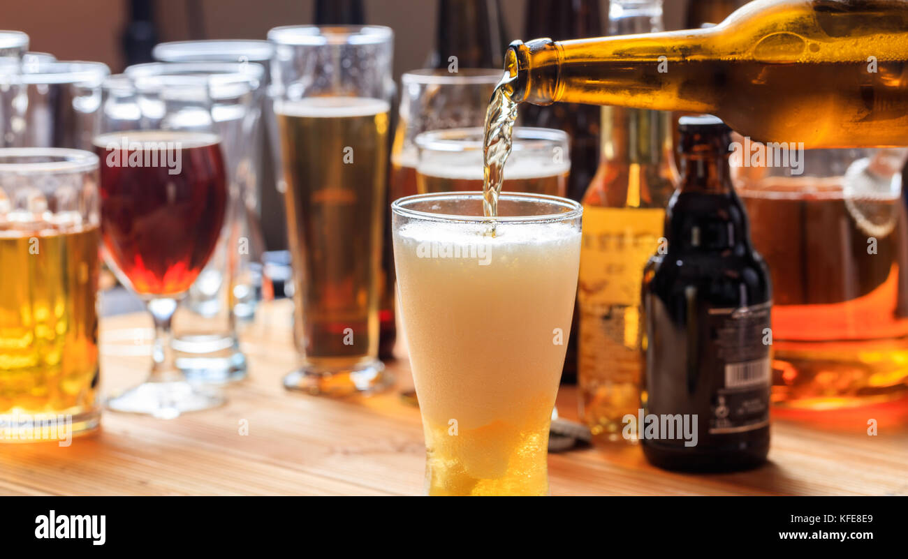 Pouring beer in a frosty glass of beer on a pub background Stock Photo