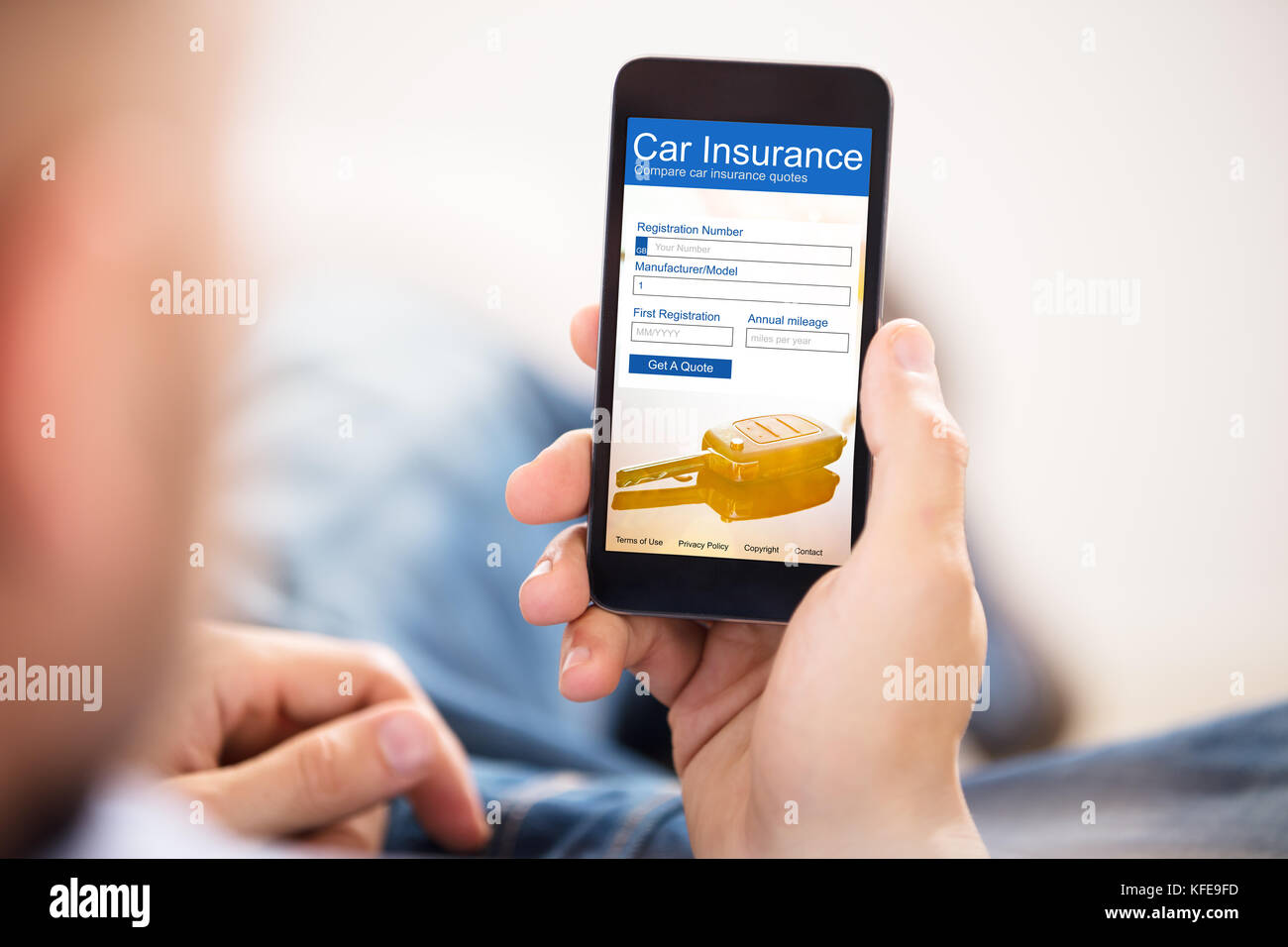 Close-up Of A Man Filling Car Insurance Form On Mobile Phone Stock Photo