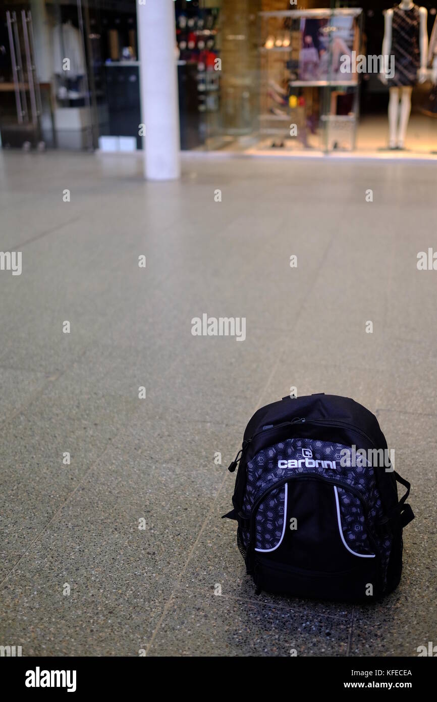 An abandoned backpack treated as a suspicious package in a busy public place Stock Photo