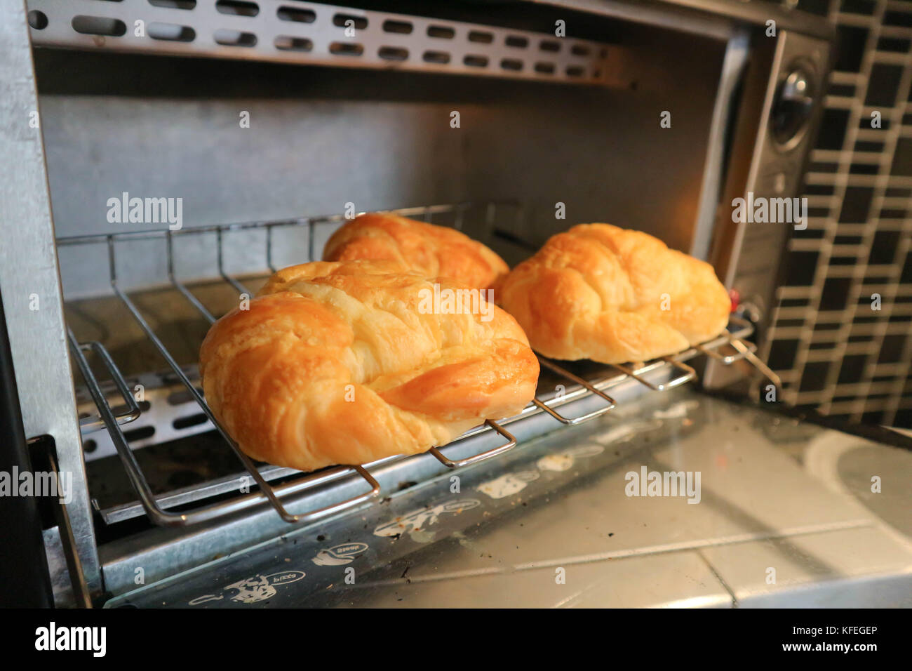 croissant or French bread in the oven Stock Photo Alamy