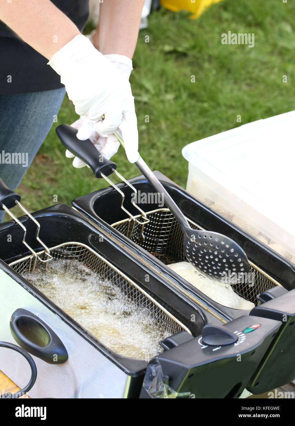 cook with latex glove while frying a spring roll in the street food